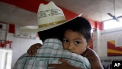 A supporter of Kenyan opposition leader Raila Odinga of the National Super Alliance (NASA) coalition jumps from a bus after riot police fired teargas canisters to disperse protesters after his swearing-in ceremony in Nairobi.