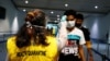 Health Quarantine officer checks people with a thermal scanner after Indonesia confirmed its first cases of coronavirus disease (COVID-19), in Soekarno Hatta International Airport, in Tangerang near Jakarta, Indonesia, March 6, 2020. 