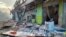 Debris lies on the street outside damaged shops in Chinatown, Honiara, Solomon Islands, Nov. 26, 2021.