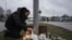 A man lights candles at a makeshift vigil in Orebro, Sweden, on Feb. 5, 2025 after a shooting at the adult education center Campus Risbergska school, where 11 people were killed.