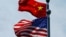 FILE - A Chinese and U.S. flag flutter near The Bund, before U.S. trade representatives meet with their Chinese counterparts for talks in Shanghai, China, July 30, 2019.
