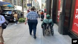 ຜູ້​ຊາຍ​ທີ່​ມີ​ນ້ຳ​ນັກ​ສູງ​ຄົນ​ນຶ່ງ​ຍ່າງ​ຢູ່​ຖະ​ໜົນ​ໃນ​ນະ​ຄອນ ນິວຢອກ, 19 ກັນ​ຍາ 2023.(AP Photo/Ted Shaffrey)