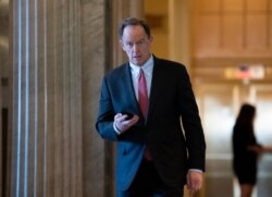 FILE - Sen. Pat Toomey returns from a break in the impeachment trial of President Donald Trump on charges of abuse of power and obstruction of Congress, at the Capitol in Washington, Feb. 3, 2020.