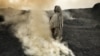 A woman tends fires of burning coal at a village outside Djaria, India. (Credit: Larry C. Price)