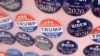 FILE - Biden for President campaign buttons are for sale beside "Impeach Trump Now!" buttons as U.S. Democratic presidential candidate and former Vice President Joe Biden meets union workers at the Teamsters Local 249 hall in Pittsburgh, April 29, 2019.