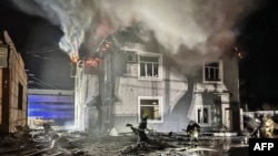 乌克兰紧急服务部门发布照片显示，救援人员正在扑灭基辅遭无人机袭击的一座行政大楼的大火。（2024年1月30日）