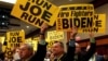 Supporters hold signs as former Vice President Joe Biden addresses the International Association of Fire Fighters in Washington, March 12, 2019.