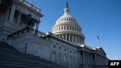 FILE - A U.S. flag flies near the dome of the U.S. Capitol in Washington, Feb. 25, 2025. 