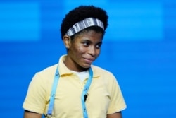 Zaila Avant-garde, 14, from Harvey, Louisiana, reacts after correctly spelling a word during the finals of the 2021 Scripps National Spelling Bee at Disney World, July 8, 2021, in Lake Buena Vista, Fla.