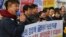 North Korean defectors stage a rally denouncing the deportation of North Korean fishermen in Seoul, South Korea, Nov. 12, 2019. The sign reads: "Apologize for the government of Moon Jae-in who deported the defectors." 