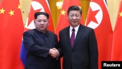 北韓領導人金正恩(左)對華秘密訪問期間，3月28日與中國領導人習近平舉行了會談。