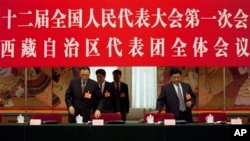 西藏自治區人大主任白瑪赤林（右）和西藏自治區主席向巴平措（左）進入北京人民大會堂內人大會議西藏自治區代表團的討論會場。