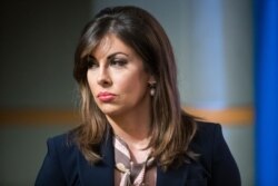 FILE - State Department spokeswoman Morgan Ortagus stands as Secretary of State Mike Pompeo speaks with reporters at the State Department, Nov. 26, 2019 in Washington.
