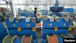 中國浙江省湖州市的一個通訊設備廠光纖生產線上的工人正在工作。 （2020年5月15日）