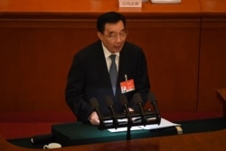 中国全国人大副委员长王晨在北京人大会堂举行的全国人大年度会议开幕式上讲话。（2021年3月5日）