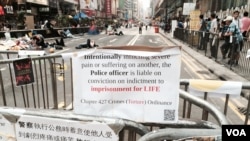 旺角佔領區在法庭頒發禁制令後仍有數十名示威者在日間留守，並張貼諷刺警方的標語 (美國之音 湯惠芸拍攝)