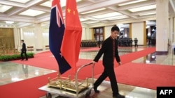 北京人大會堂一名工作人員在運送中國和新西蘭國旗。 （2019年4月1日）