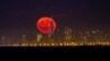 The moon rises behind One World Trade Center on a clear night in Lower Manhattan neighborhood of New York, as seen from Green Brook Township, N.J., Tuesday, Oct. 15, 2019. 
