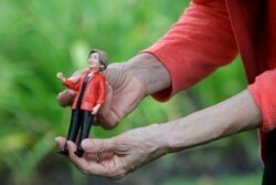 Democratic presidential candidate Sen. Elizabeth Warren, D-Mass., holds an Elizabeth Warren doll given to her at a campaign event, Sept. 2, 2019, in Hampton Falls, N.H.