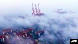 2025 年 2 月 16 日，上海洋山深水港的船舶和貨櫃被霧氣籠罩。(法新社資料照片)