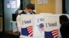 A man wears a face mask as he votes at an early voting site in Arlington, Virginia, U.S., September 18, 2020. 
