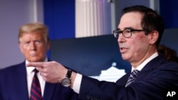 FILE - President Donald Trump listens as Treasury Secretary Steven Mnuchin speaks about the coronavirus at the White House, April 2, 2020.