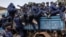 Congolese police officers board trucks after an enrollment of civilians, police officers, and former members of the Armed Forces of the Democratic Republic of Congo who allegedly decided to join the M23 movement voluntarily in Bukavu, Democratic Republic of Congo, Feb. 22, 2025.