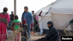 ອົບພະຍົບ ອີຣັກ ພັກຜ່ອນຢູ່ໃກ້ຕູບຜ້າໃນສູນອົບພະຍົບ ອີຣັກ ແຫ່ງນຶ່ງໃນບ້ານ ມາບຣູກາ ເມືອງ ຣາສ-ອາລ-ເອນ, ປະເທດ ຊີເຣຍ. 31 ມັງກອນ, 2016. 