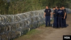 Andrew Roussos puts a hand around his son Xander as he carries his daughter Saffie Rose Roussos&#39; coffin, the youngest victim of the bombing of the Manchester Arena, at her funeral at Manchester Cathedral, Britain.
