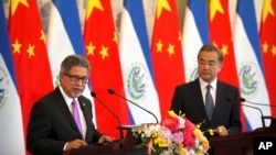 A Taliban fighter stands guard at a checkpoint on a street in Kabul.