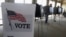 FILE - Voters cast ballots in Hinsdale, Ill., March 18, 2014. 