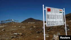 FILE - A signboard is seen from the Indian side of the Indo-China border at Bumla, in the northeastern Indian state of Arunachal Pradesh, Nov. 11, 2009. 