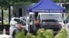 A forensic worker looks for evidence as police officers patrol the site of an attack on a prison van at a road toll in Incarville, France, on May 14, 2024.