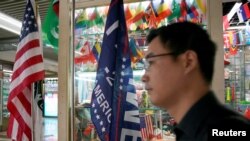 A flag of the U.S. President Donald Trump's "Keep America Great!" 2020 re-election campaign and the U.S. flag are seen in a flag stall at the Yiwu Wholesale Market in Yiwu, Zhejiang province, China, May 10, 2019.