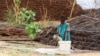 FILE - A displaced Sudanese child pours water at Zamzam camp, in North Darfur, Sudan, Aug. 1, 2024. 