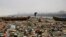 A fisherman walks on the shores of the Arabian Sea, littered with plastic bags and other garbage, in Mumbai, India.