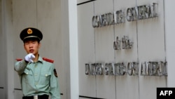 在美國駐成都總領事館前一名中國武警士兵做出警告的手式。 （2012年9月18日）