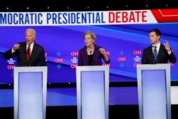 Democratic presidential candidate former Vice President Joe Biden, left, Sen. Elizabeth Warren, D-Mass., center and South Bend Mayor Pete Buttigieg speak during a Democratic presidential primary debate.