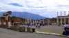 FILE - Tourists stroll past the remains of Pompeii's forum. 