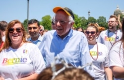 Democratic 2020 U.S. presidential candidate Senator Bernie Sanders walks with supporters as he campaigns at the Capital Pride LGBTQ gay pride celebration at the Iowa State Capitol in Des Moines, Iowa, June 8, 2019.