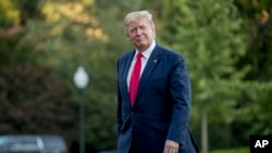 President Donald Trump walks across the South Lawn as he arrives at the White House, June 30, 2019, in Washington. 
