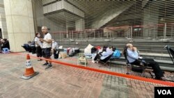 數十人提早兩至三個在西九龍裁判法院外排隊，通宵輪候民主派初選47人案的法庭旁聽席籌號。(美國之音照片)