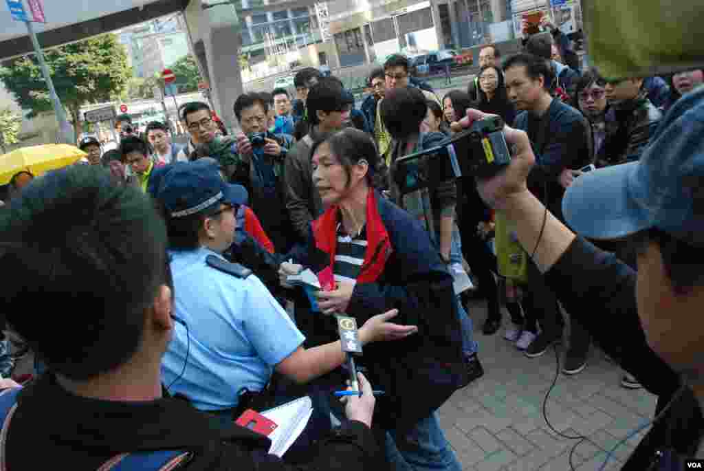 集會人士雷玉蓮(手持粉筆盒者)與駐守的女警發生口角