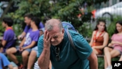 Russ Wilson splashes water on his face from a fountain in New York, July 17, 2019. The heat wave that has been roasting much of the U.S. in recent days is just getting warmed up, with temperatures expected to soar to dangerous levels.