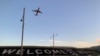 FILE - A sign painted near the runway of the Wellington International Airport greets travelers in Wellington, New Zealand, April 19, 2021. 