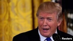 Visitors gather during a presentation visit of the &quot;Grand Palais Ephemere&quot;, with the Eiffel Tower seeing outside, in Paris, France.