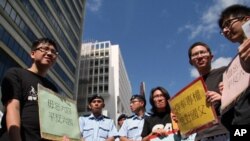 A survivor supported by rescuers, is taken onto shore after a collision involving two vessels in Hong Kong, October 2, 2012.