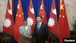 Children play on a cell phone at a market in New Delhi, India.