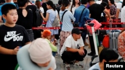 香港航空業人士參加8.5大罷工,乘客2019年8月5日在香港國際機場排隊等候。