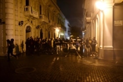 Hundreds of people joined a protest Thursday organized by Puerto Rican singer Rene Perez of Calle 13 fame in anger over emergency aid that until recently sat unused in a warehouse amid ongoing earthquakes.